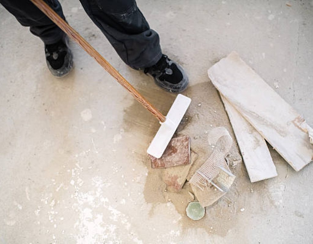 Cleaning crew wiping down walls and fixtures after construction work